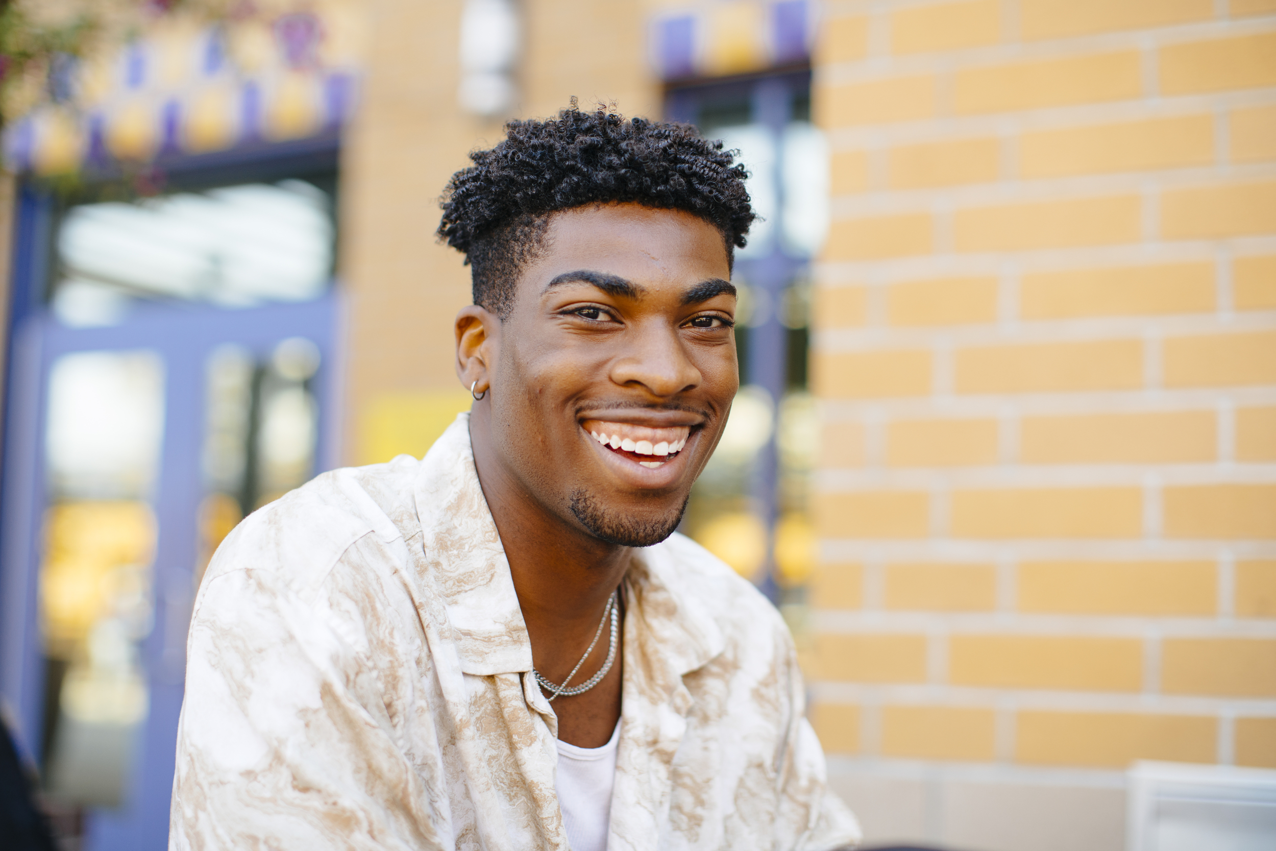 Smiling student in front of campus building